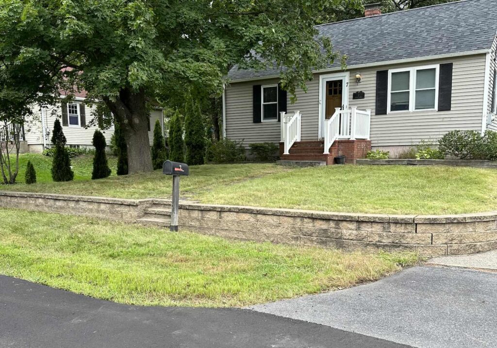 Freshly mowed lawn after overgrown landscape cleanup in Kittery Maine