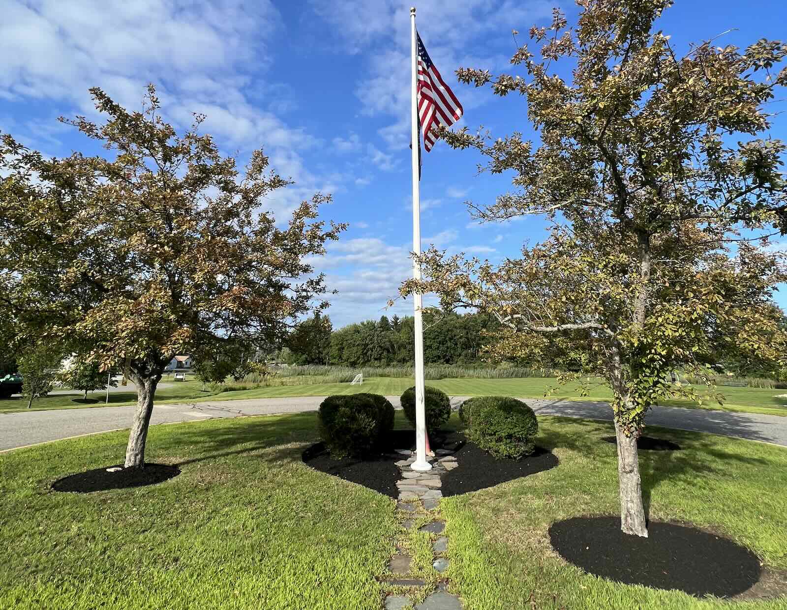 Fresh mulch and neatly trimmed shrubs after landscape bed cleanup in Newington NH