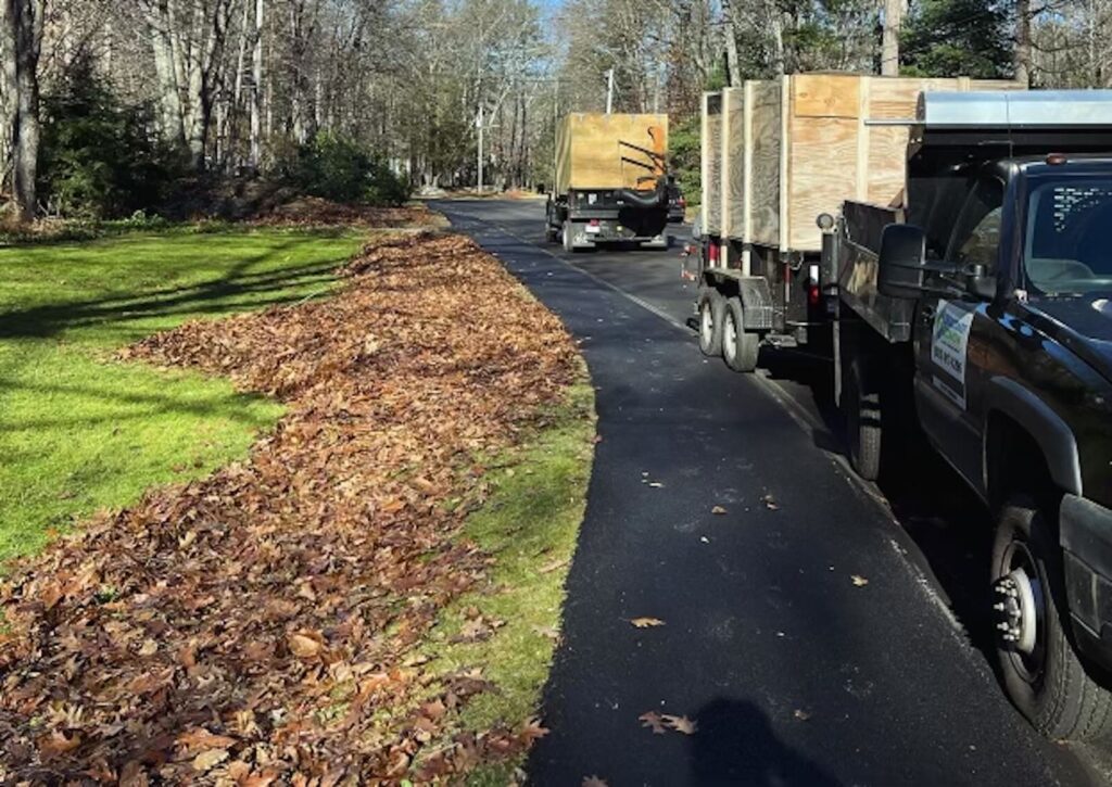 Pile of leaves along roadside ready for leaf vacuum pickup during fall cleanup in Greenland NH