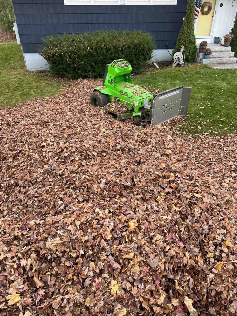 Leaf removal service using mower leaf plow at residential property in Dover NH