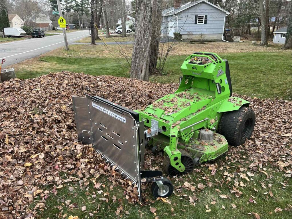 Fall leaf cleanup using mower leaf plow to clear large leaf pile in Portsmouth NH
