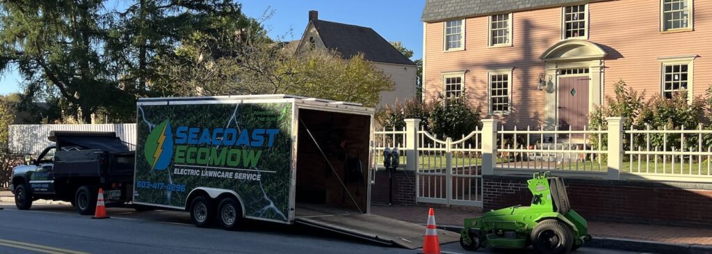 Seacoast EcoMow truck trailer and mower parked in front of historic home during landscaping service in New Castle NH