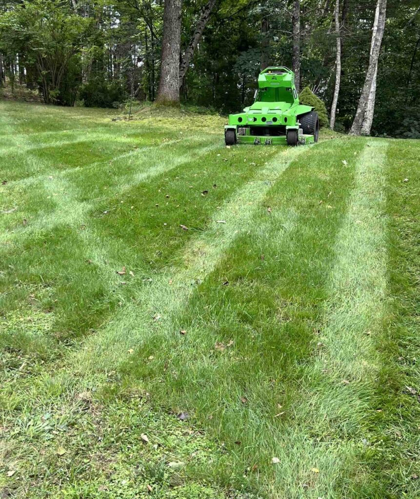 Mean Green mower on freshly striped lawn during landscaping service in Portsmouth NH