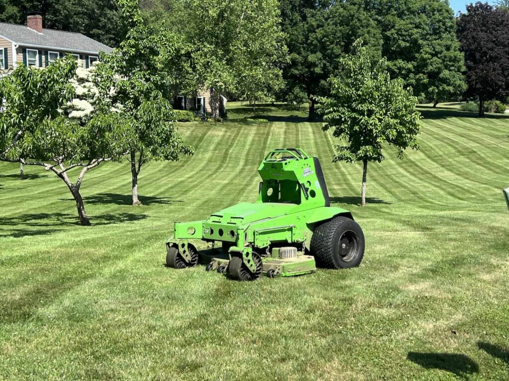 Electric lawn mowing service maintaining residential lawn in Newington NH