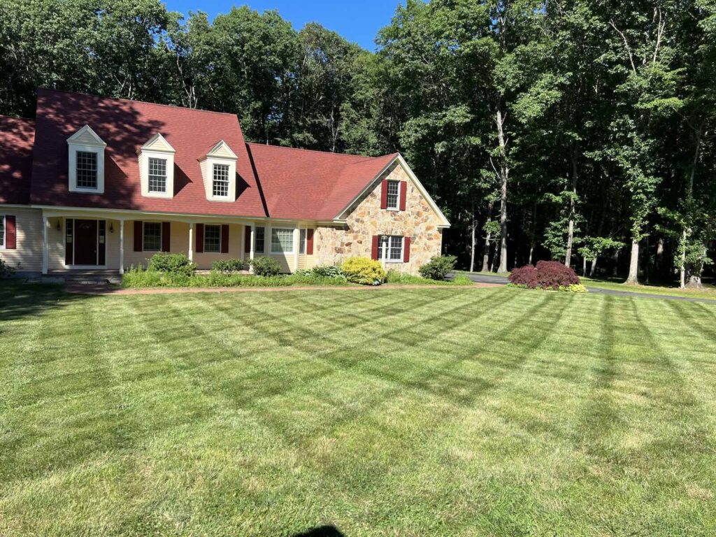 Striped residential lawn after professional mowing service in Rye NH