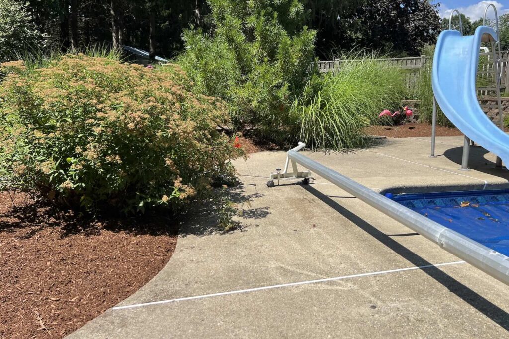 Fresh mulch installation around pool landscape beds in Greenland NH
