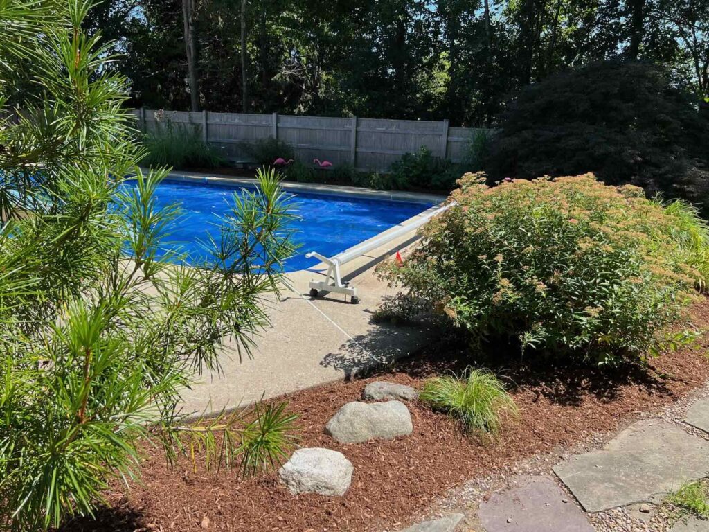 Fresh mulch installation around landscape beds in Stratham NH